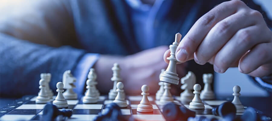 Close up of male hand making a chess move.