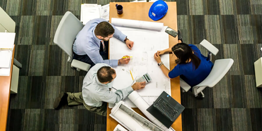 Birds eye view of a group of construction professionals having a meeting.