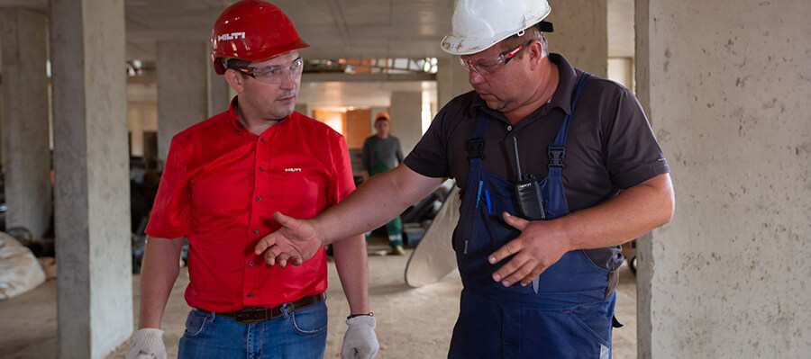 Contractors talking about the job while on the building site.