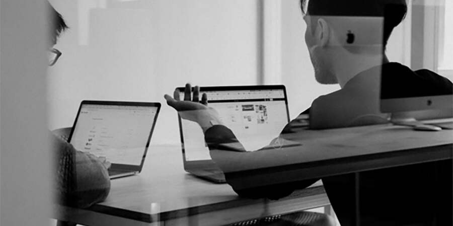 Two people working on laptops.