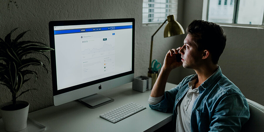 Ethical hacker with laptop on desk.