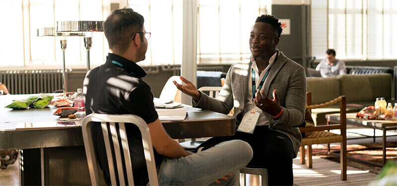 Two gentlemen discussing fundraising.