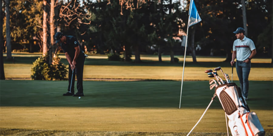 Two golfers practicing their skills.