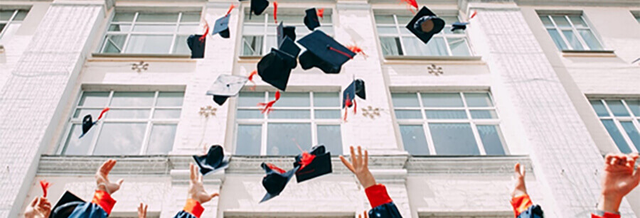 Graduates throwing their hats in the air.