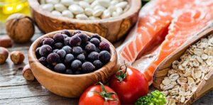 Healthy foods including nuts, blueberries, pluses and oily fish