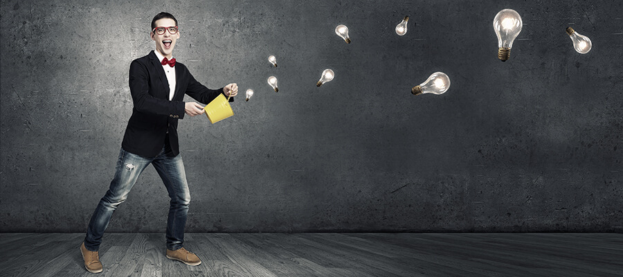 Inventor throwing light bulbs from a yellow bucket.