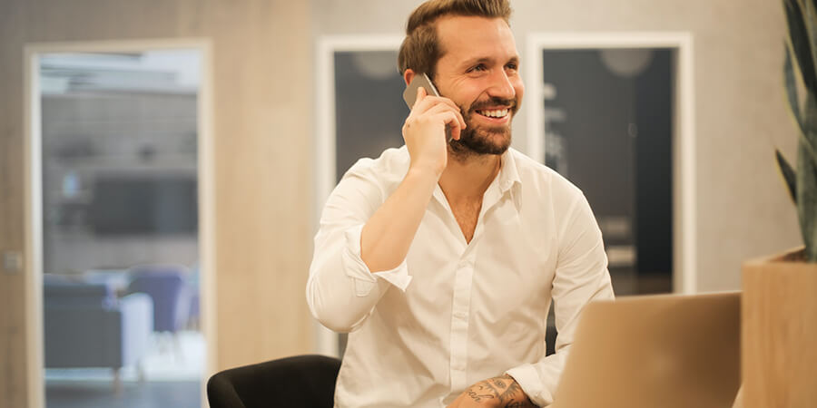 Man in office on the phone.