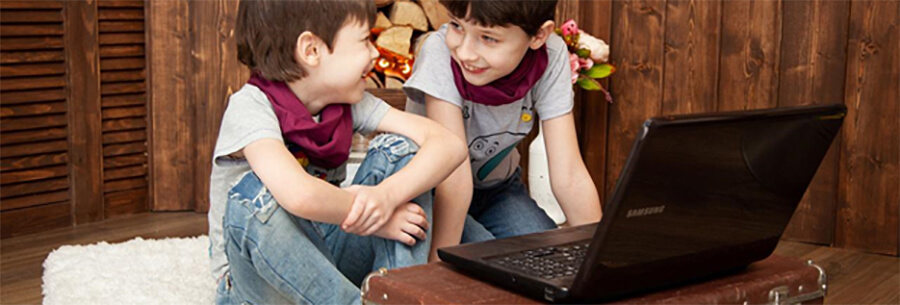 Two young children with a laptop.