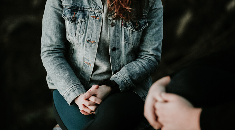 Close up of a woman talking to a therapist.