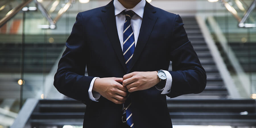 Man dressed smartly in a suit and tie.