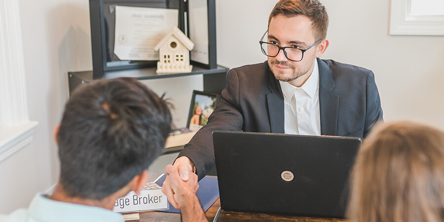 Mortgage broker shaking hands with a client.