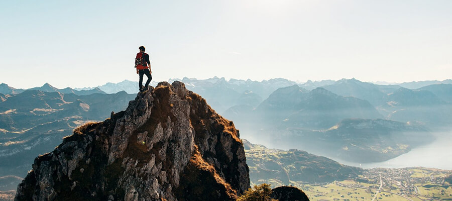 Mountain climber enjoying the view from the top of a mountain.