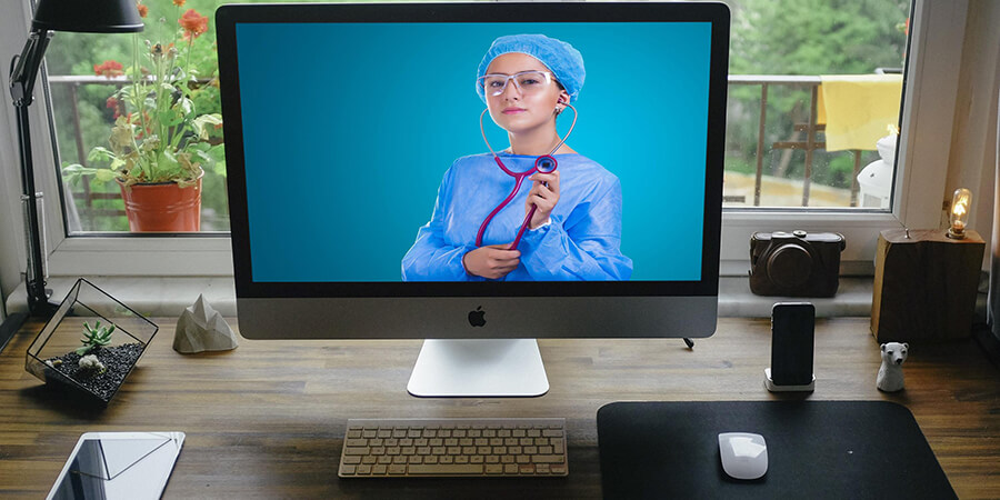 Online healthcare learning, large monitor with an image of a nurse.