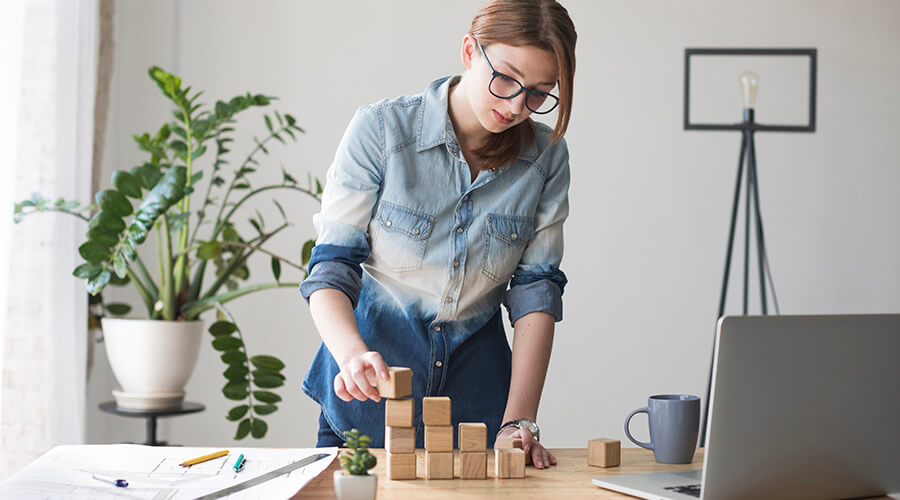 Young woman using building blocks in the office.