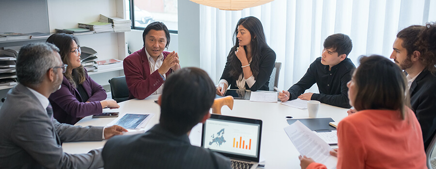 Group of business people having a meeting around a large table.