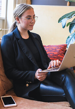 Woman proof reading on a laptop.