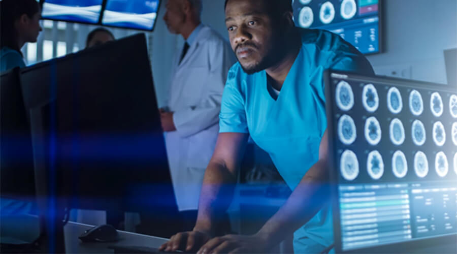 Man logging off from a computer in a hospital.