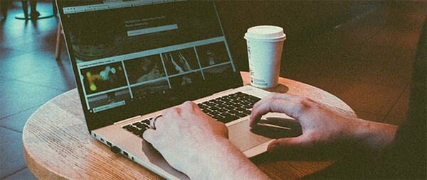 Remote worker using a laptop in a cafe.