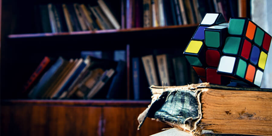 Old book and Rubik's Cube.