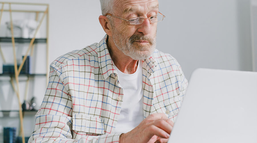 Senior using a laptop.