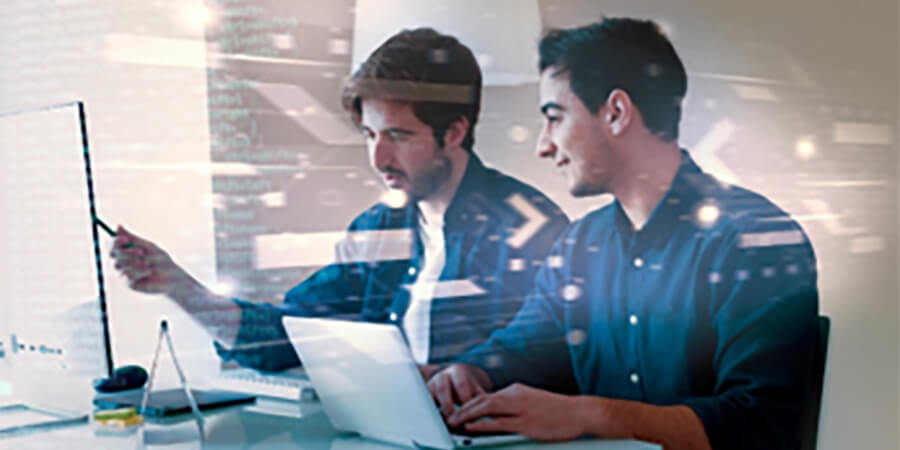 Two people working on computers.