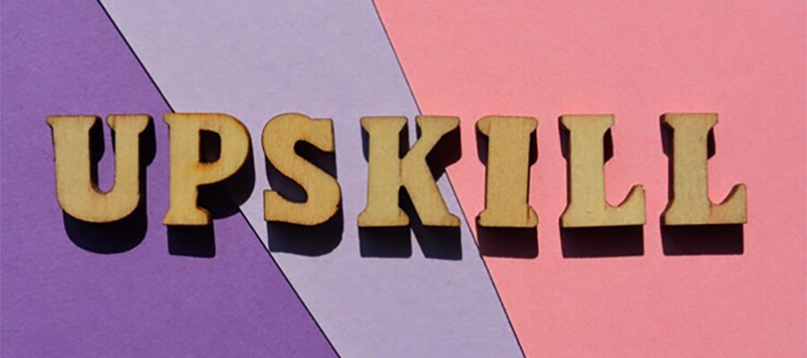 The word 'Upskill' in yellow letters on a multicoloured background.