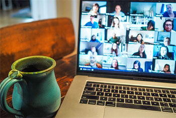 Laptop showing video conference calling software.