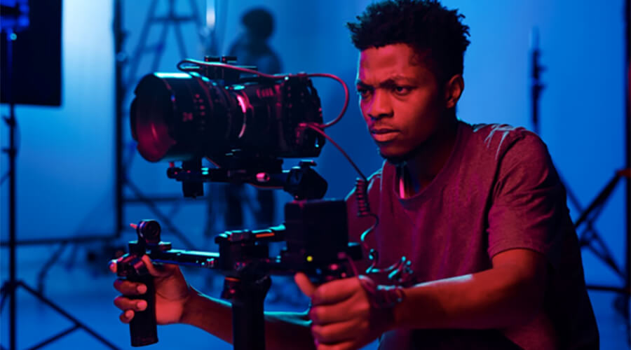 Man using a video camera in a studio.