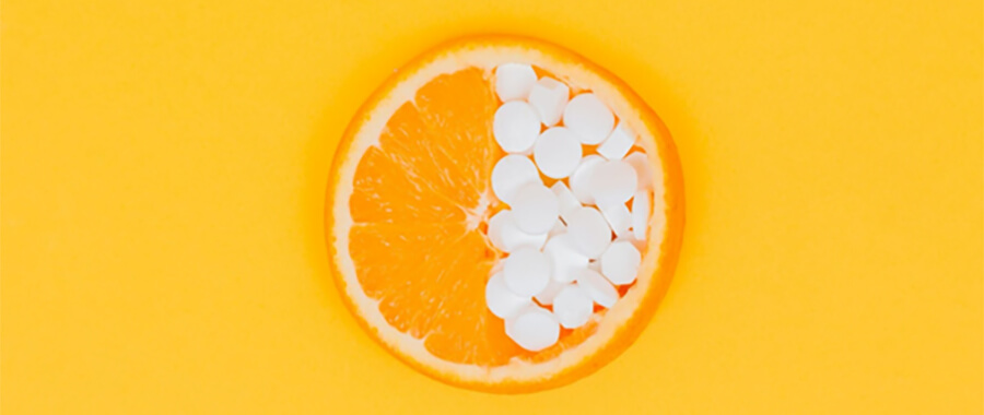 Orange and vitamin C tablets.