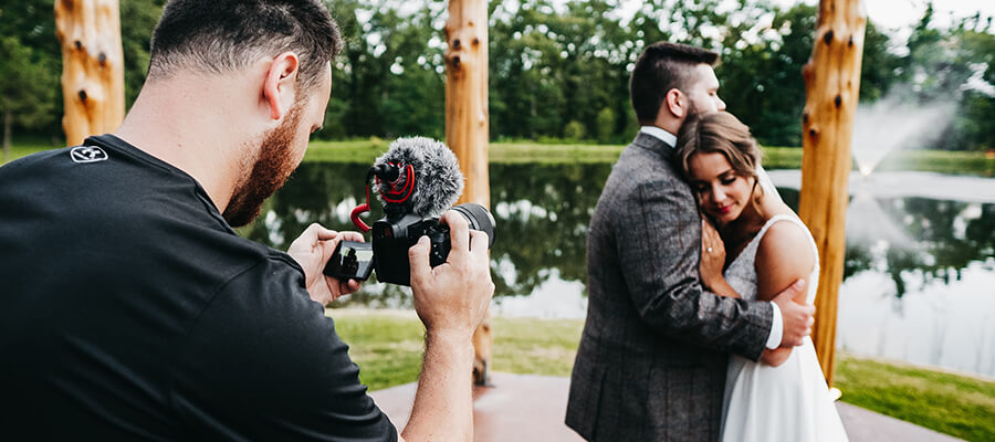 Professional wedding photographer taking a picture of the bride and groom.