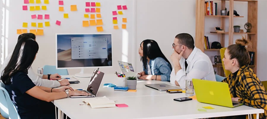 Group of people meeting around a white table